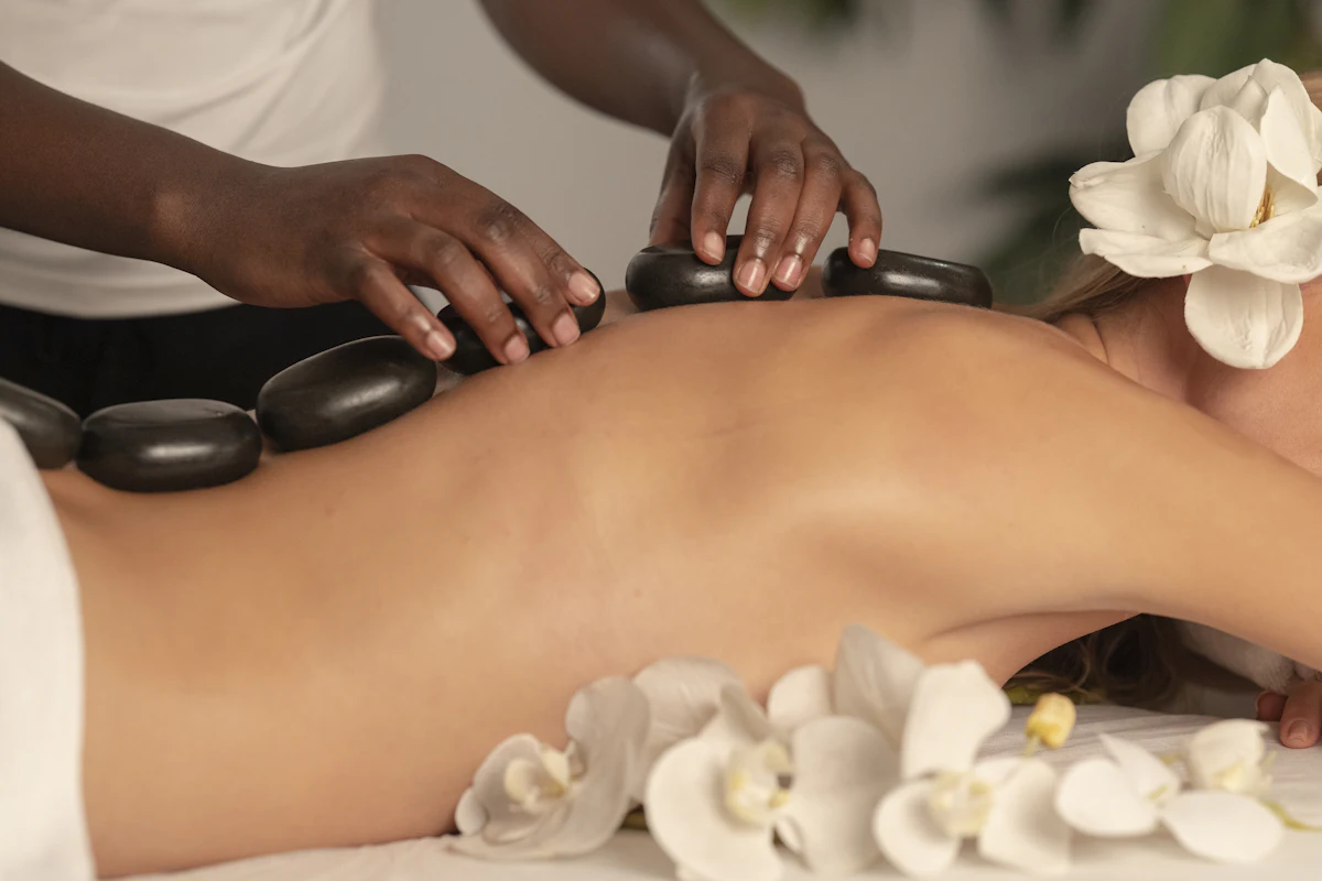 Warm basalt stones and rolled towels at High Stone Wholistic Wellness